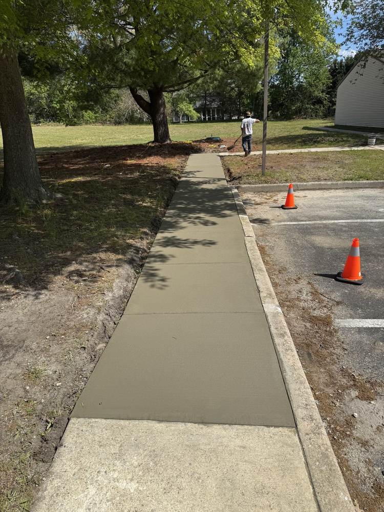 Commercial concrete sidewalk near a parking lot by South Jersey Construction Enterprise