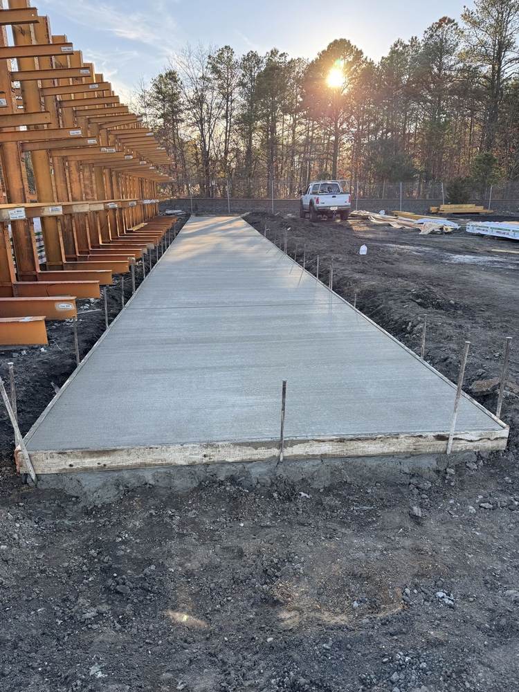 Commercial concrete slab at a lumber yard finished at sunset by South Jersey Construction Enterprise