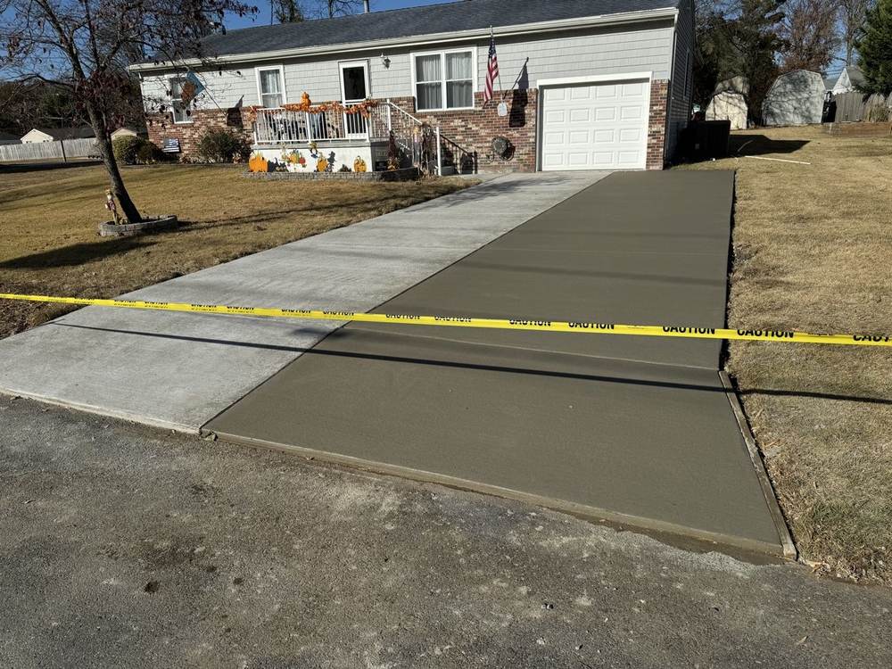 Concrete driveway extension poured beside an existing driveway by South Jersey Construction Enterprise