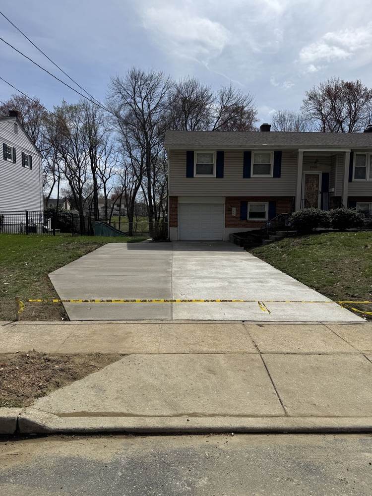 Fresh concrete driveway with caution tape by South Jersey Construction Enterprise