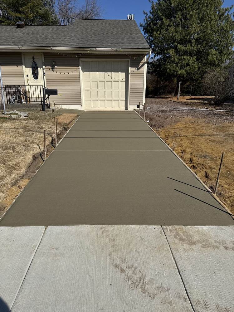 Fresh concrete driveway poured to a garage by South Jersey Construction Enterprise