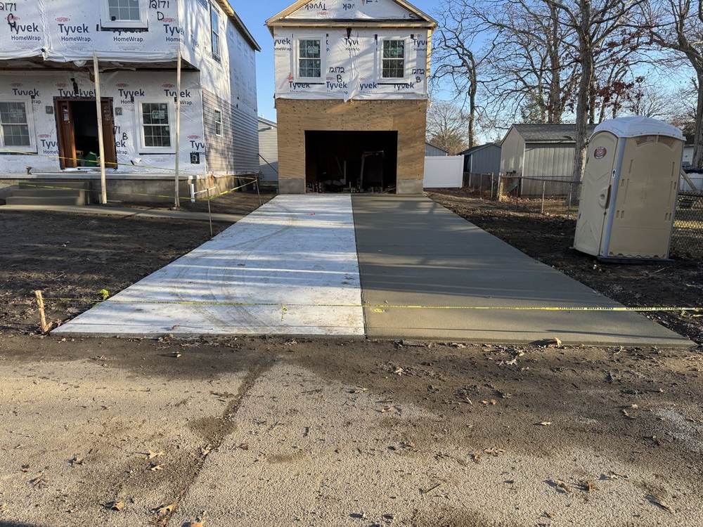 New concrete driveway poured at a new-construction home by South Jersey Construction Enterprise