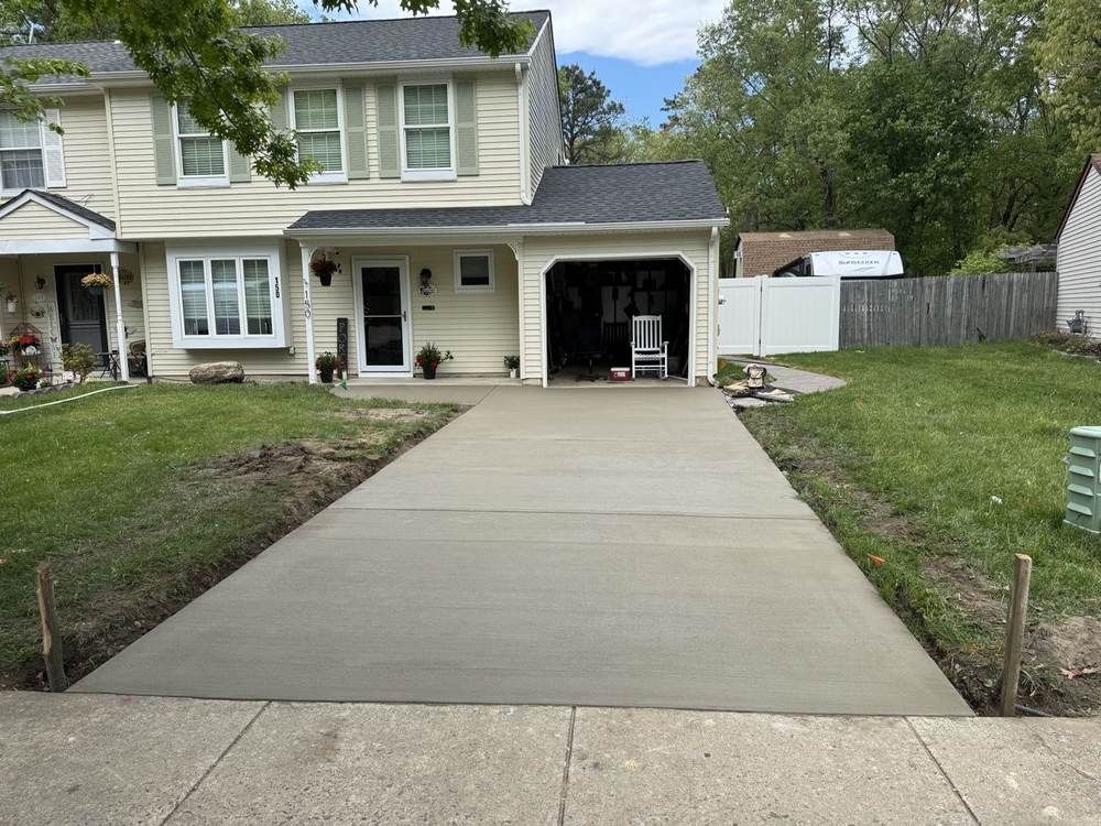 Fresh concrete driveway for a townhouse by South Jersey Construction Enterprise