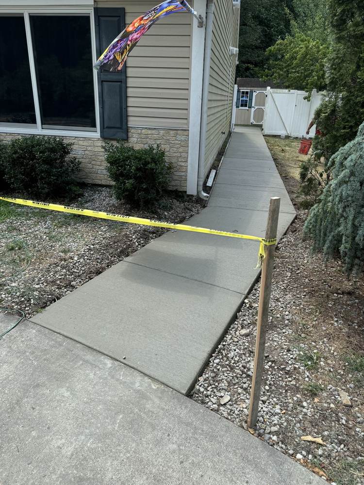 Wide cured concrete driveway installed by South Jersey Construction Enterprise