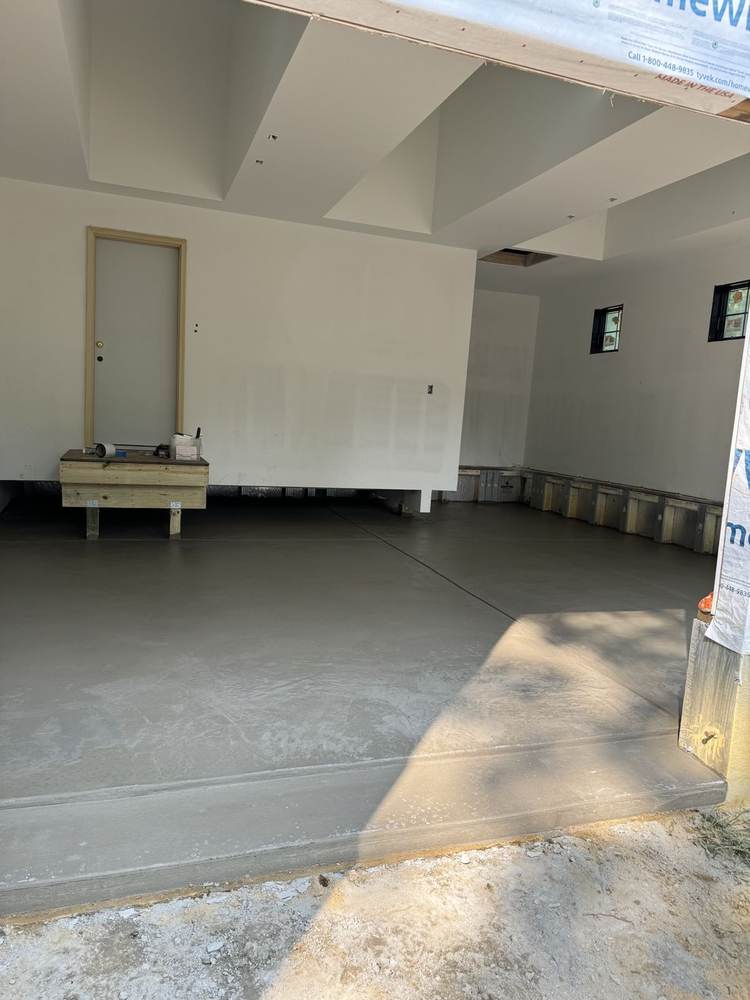 Newly finished interior concrete garage floor in new construction by South Jersey Construction Enterprise