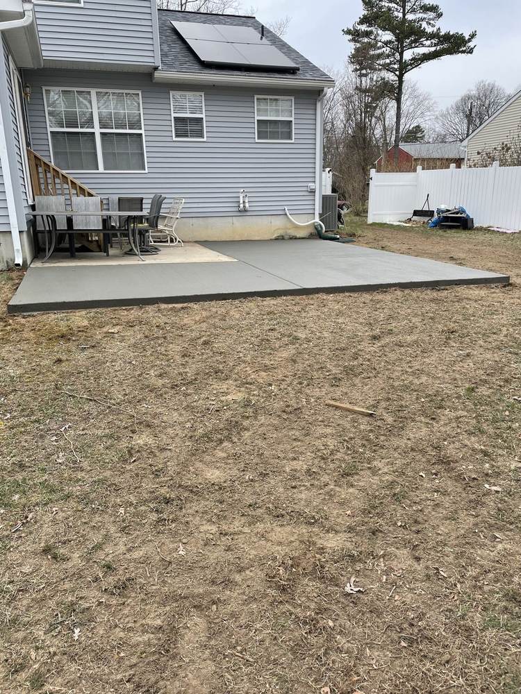 Crew edging a large fresh concrete patio pour by South Jersey Construction Enterprise