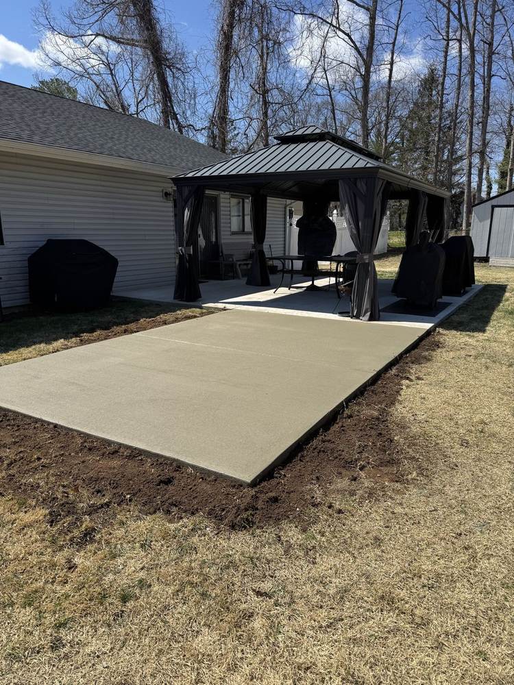 Fresh concrete patio extension under a backyard gazebo by South Jersey Construction Enterprise