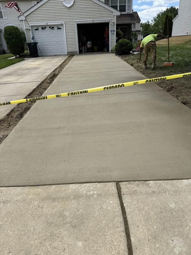 New concrete patio installed by South Jersey Construction Enterprise under a raised deck
