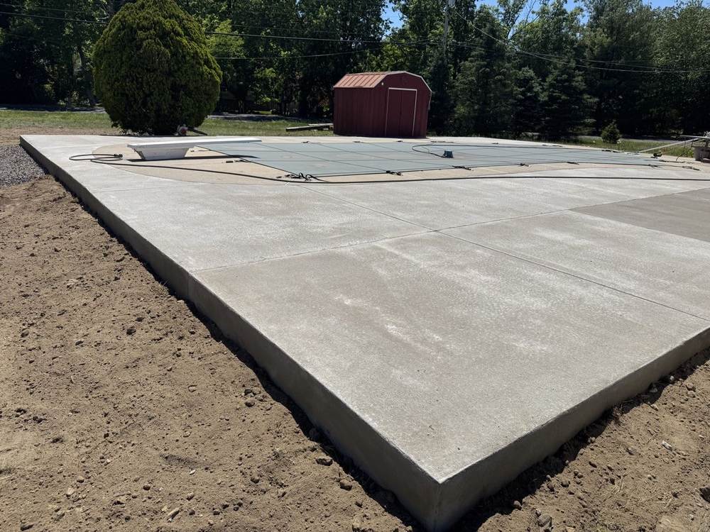 Large concrete pool deck poured around a covered pool by South Jersey Construction Enterprise