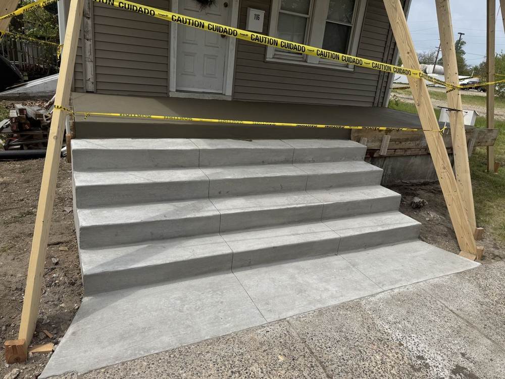 New concrete porch steps with caution tape by South Jersey Construction Enterprise, side angle