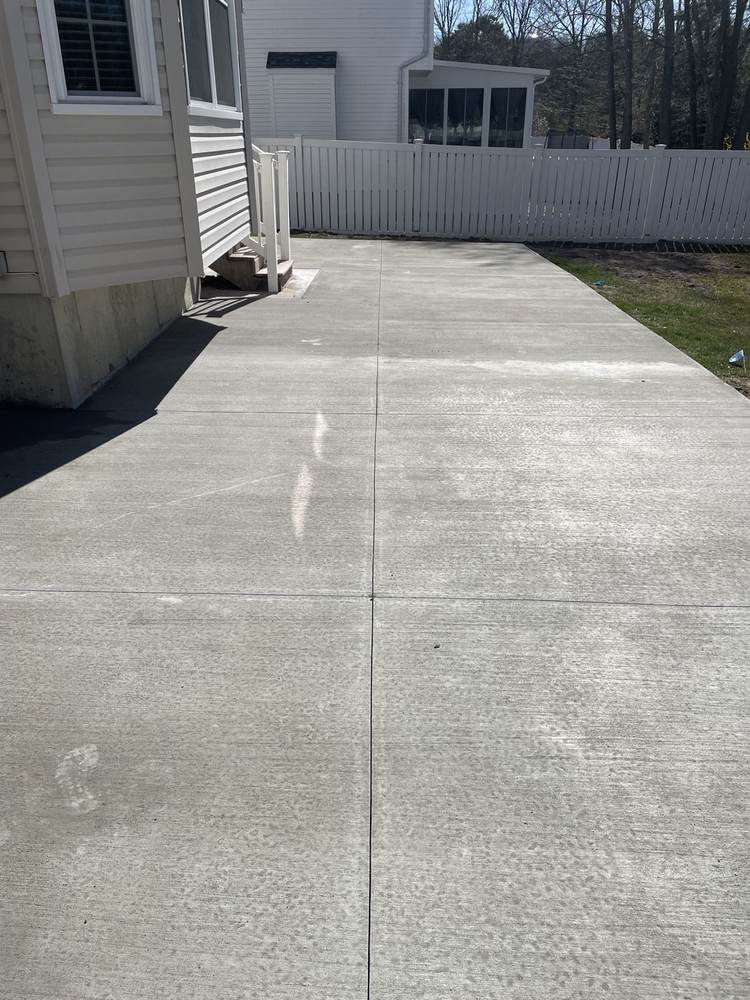 Concrete porch stoop with steps installed for a brick home by South Jersey Construction Enterprise
