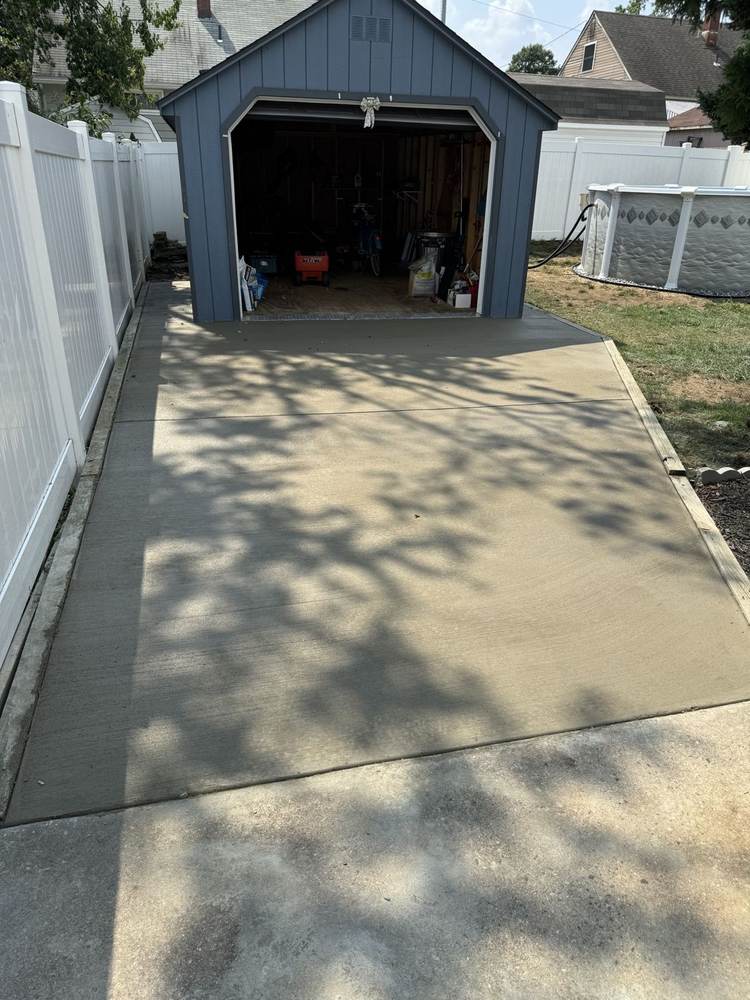 Concrete pad poured in front of a backyard shed by South Jersey Construction Enterprise