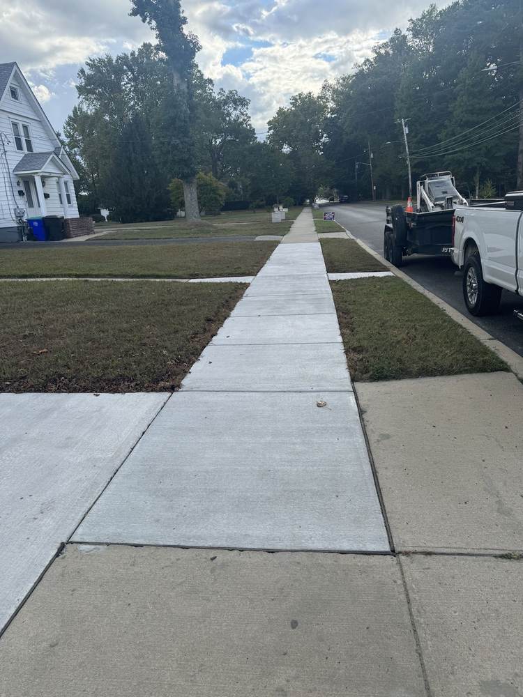 Long concrete sidewalk running to the street by South Jersey Construction Enterprise