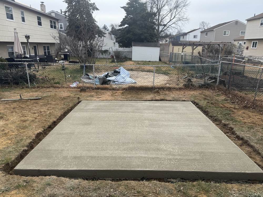 Finished concrete slab in a backyard by South Jersey Construction Enterprise