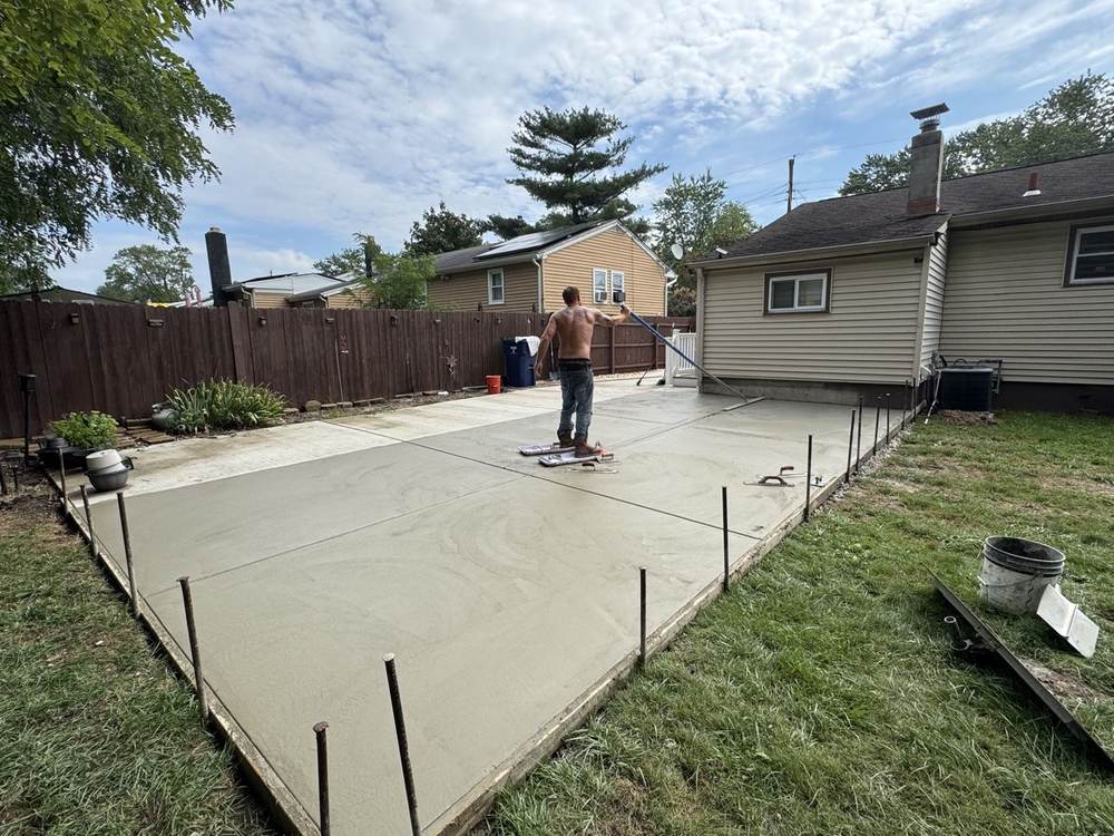 Crew member hand-finishing a fresh concrete slab for South Jersey Construction Enterprise