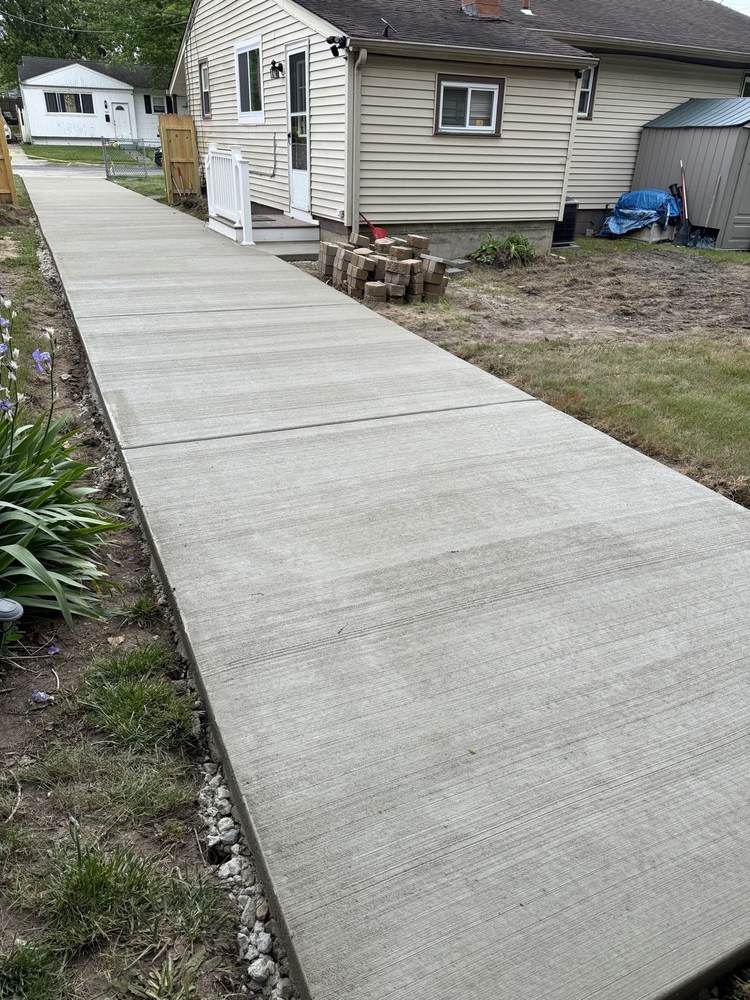 New concrete slab pad installed by South Jersey Construction Enterprise near an above-ground pool