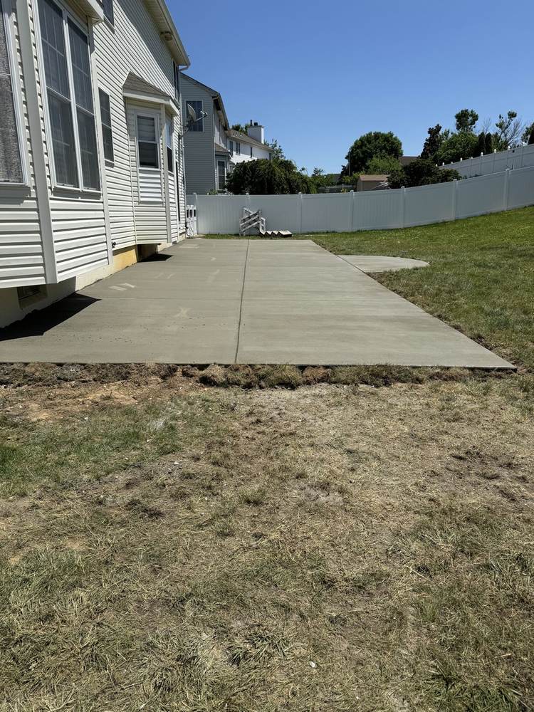 New concrete slab pad installed by South Jersey Construction Enterprise in a sandy yard