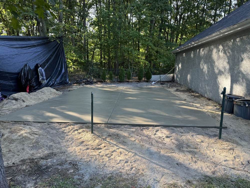 Concrete slab pad poured in a sandy yard by South Jersey Construction Enterprise