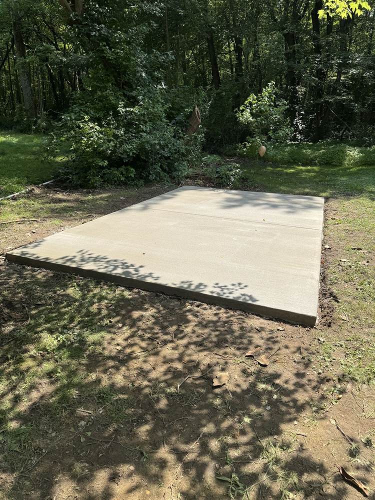 New concrete slab pad poured in a wooded clearing by South Jersey Construction Enterprise