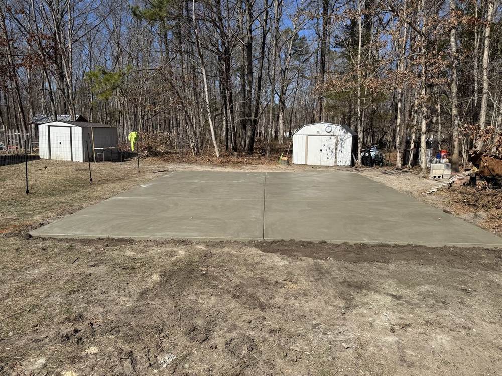 Large concrete slab pad poured in a wooded lot by South Jersey Construction Enterprise