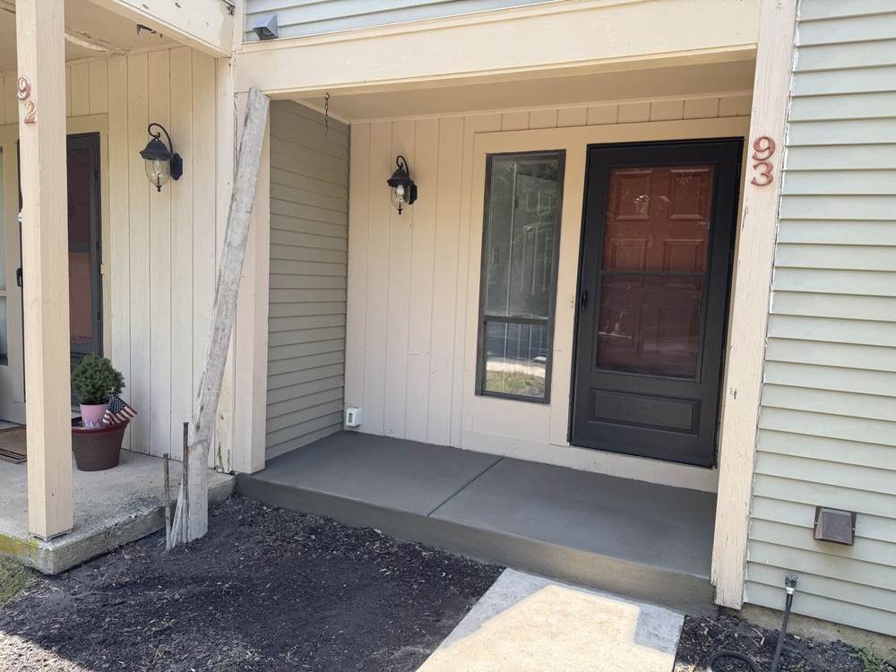 New concrete steps and landing installed at a townhouse entry by South Jersey Construction Enterprise