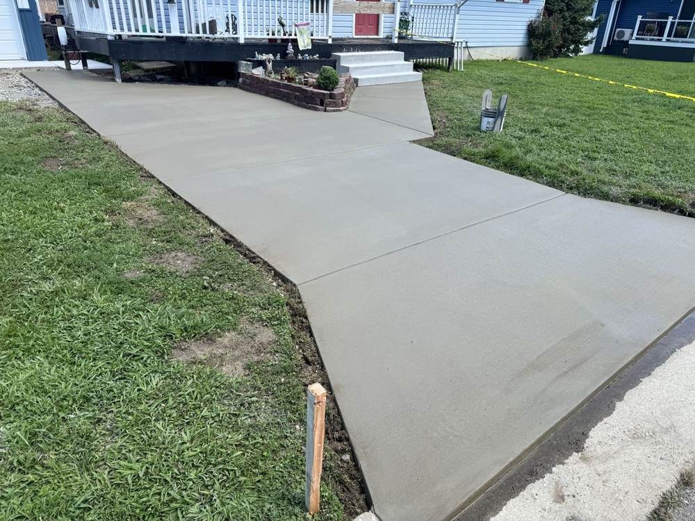 New concrete walkway with steps leading to a home entrance by South Jersey Construction Enterprise