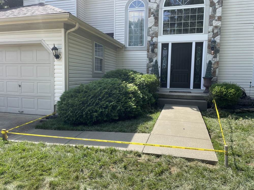 New concrete front walkway to a stone-facade home by South Jersey Construction Enterprise